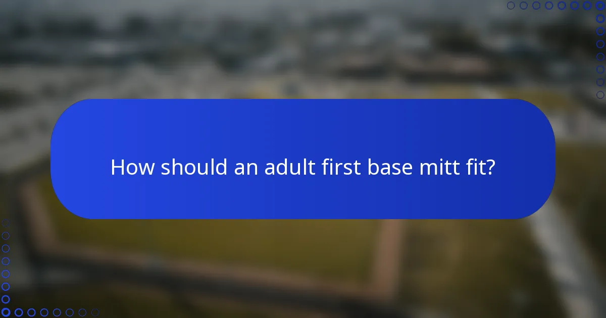 How should an adult first base mitt fit?